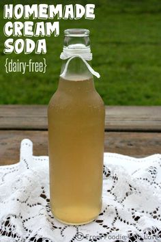 a bottle of homemade cream soda sitting on top of a doily