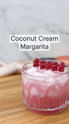 there is a small dessert in a glass on the table with text overlay that reads coconut cream margarita