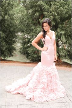 a woman in a pink dress posing for the camera