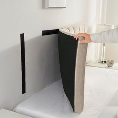 a person is opening the back of a bed