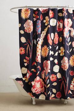 the shower curtain is decorated with colorful flowers and leaves on dark blue, red, orange, pink, yellow, white colors