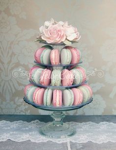 there are many macaroons on the cake stand