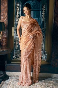 Copper saree features all over tonal sequin and crystal embroidery in a floral pattern. Comes with fully embroidered strappy, padded blouse with tassels at the waist and a petticoat. - Aza Fashions Strappy Blouse, Seema Gujral, Sequin Saree, Crystal Embroidery, Set Saree, Saree Gown, Indian Fashion Designers, Blouse Styles, Indian Wear