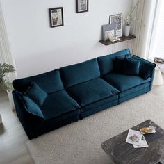 a living room with a blue couch and coffee table