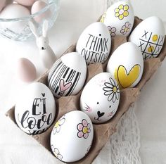 an egg carton filled with painted easter eggs