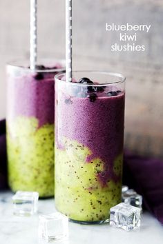 two glasses filled with food sitting on top of a table