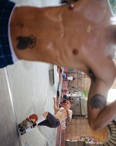 a skateboarder doing tricks on his board at the top of a half pipe