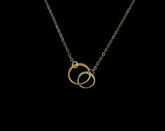 Two circles - one silver, one gold - the perfect contrast, the perfect pairing. Each is its own unique example of beauty - together, they create the world in all its richness. Each silver circle is in highly polished solid sterling silver, each gold ring is in lustrous matte 24k gold plated sterling silver. The perfect combination. The chain and spring clasp are in gold filled. This Large set of rings measures: Silver Ring: 9 x 9 mm or 3/8 x 3/8 inches (in solid sterling silver) Gold Ring: 12 x1 Minimalist Yellow Gold Jewelry For Bridesmaid Gift, Delicate Gold Jewelry For Anniversary Gift, Gold Sterling Silver Jewelry For Anniversary, Sterling Silver Gold Jewelry For Anniversary, Sterling Silver Gold Jewelry For Anniversary Gift, Handmade Gold Jewelry For Wedding Gift, Gold Jewelry For Mother's Day Wedding Gift, Gold Jewelry For Wedding Gift On Mother's Day, Set Of Rings