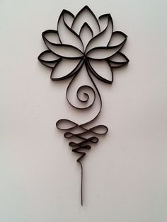 a metal wall hanging with a flower on it