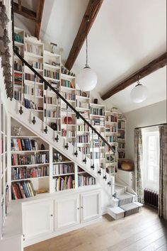 a room with bookshelves and stairs in it