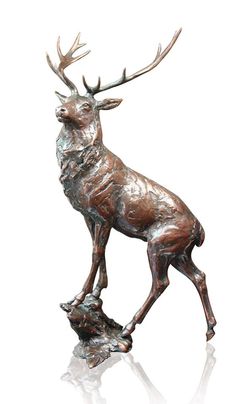 a bronze statue of a deer with antlers on it's back