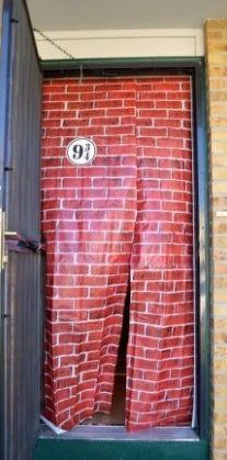 an open door with a red brick wall and the number 10 on it's side