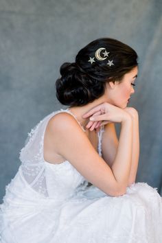 a woman in a white dress is sitting down