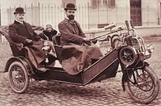 an old time photo of two men and a child in a motorcycle sidecar,