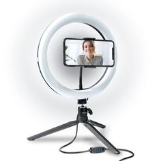 a white light with a woman's face on it and a tripod stand