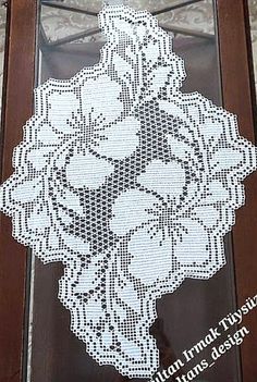 a cross stitch doily hanging on the side of a door