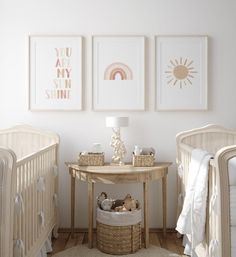 a baby's room with two cribs and three pictures on the wall