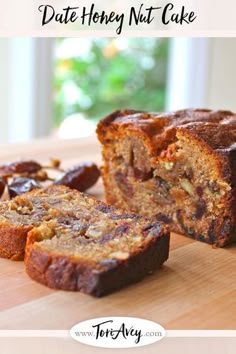 a sliced loaf of banana bread sitting on top of a wooden cutting board next to raisins