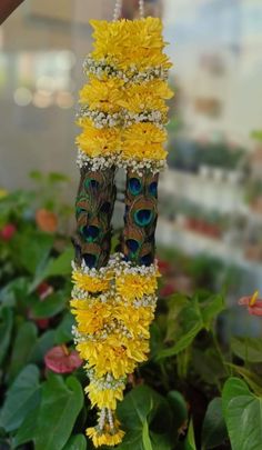 two peacocks are sitting on some yellow flowers