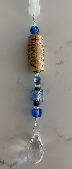 a wine bottle hanging from the side of a wall next to a glass bead