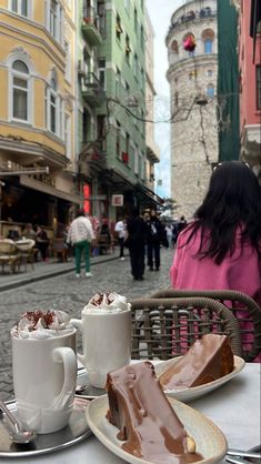 two plates with desserts on them sitting on a table in the middle of a street