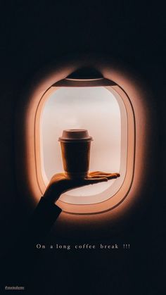 a hand holding a coffee cup in front of an airplane window with the words on a long coffee break 11