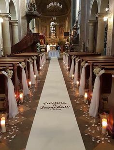 the aisle is decorated with candles and flowers