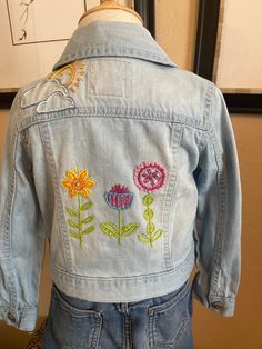 "Size 4T Osh Kosh B'gosh jacket 100% cotton Chest 12 1/2\" Shoulder 10\" Sleeve 14\"? Length 12 1/4\" The hand embroidery on the back panel and yoke is very sweet." Spring Cotton Denim Jacket With Embroidered Patch, Spring Embroidered Patch Denim Jacket, Embroidered Cotton Denim Jacket For Fall, Blue Embroidered Cotton Denim Jacket, Spring Denim Jacket With Custom Embroidery, Spring Cotton Outerwear With Embroidered Patch, Cotton Denim Jacket With Multicolor Embroidery And Pockets, Spring Denim Jacket With Custom Embroidery And Long Sleeves, Spring Cotton Outerwear With Floral Applique