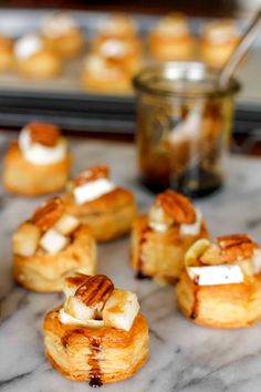 small pastries are sitting on a marble table