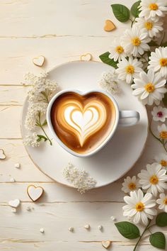 a heart shaped latte in a white cup surrounded by daisies on a saucer