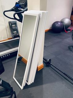 a mirror sitting on top of a gym floor