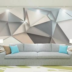 a couch sitting in front of a wall with geometric designs on the back and sides