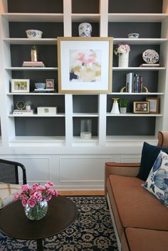 a living room filled with furniture and bookshelves