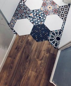 the floor is covered with different colored tiles