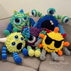 a group of crocheted stuffed animals sitting on top of a couch