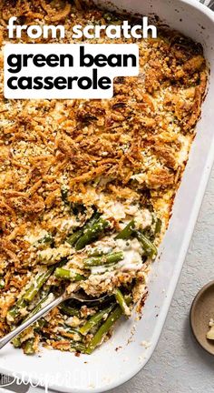 a casserole dish with green beans, cheese and bread crumbled on top