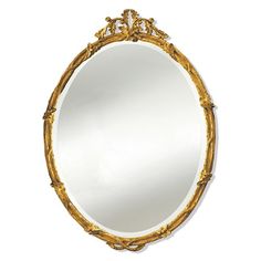 an ornate gold framed mirror on a white wall