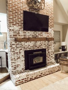 a brick fireplace with a flat screen tv mounted above it