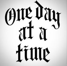 the words one day at a time written in black ink on a white paper background