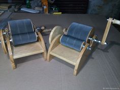 two wooden rocking chairs sitting on top of a table next to another chair with wheels