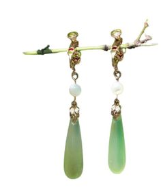 Indulge in luxury with our Chic Green Sterling Silver Alloy Pearl Drop Earrings. The alluring green stones sit delicately on the sterling silver alloy, reflecting sophistication and elegance. The perfect accessory for any occasion, these earrings will elevate your style and leave a lasting impression. Measurement: 5cm/1.95" * 0.9cm/0.351". Matches easily with daily hairstyle. dresses & Shirts Green Fine Jewelry Drop Earrings, Fine Jewelry Green Drop Earrings, Green Teardrop Clip-on Earrings, Green Clip-on Earrings For Formal Occasions, Green Sterling Silver Single Earring, Elegant Green Crystal Earrings For Pierced Ears, Green Crystal Earrings For Pierced Ears, Formal Green Teardrop Gemstone Earrings, Elegant Light Green Earrings As Gift