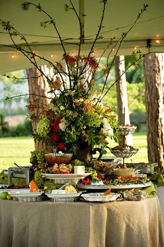 a table covered with food under a tent