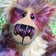 a close up of a stuffed animal with long hair and a moustache on it's face