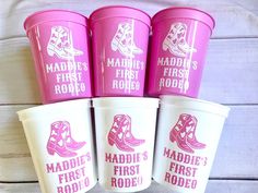 four pink cups with cowboy boots and the words maddie's first rodeo on them