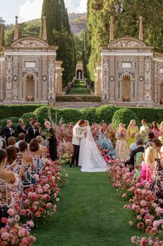 a wedding ceremony in front of an elaborate garden