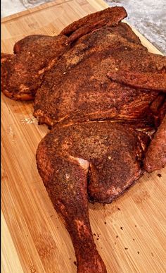 a large piece of meat sitting on top of a wooden cutting board