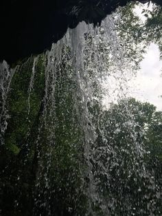 water gushing from the top of a waterfall