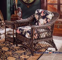 a wicker chair sitting on top of a rug in front of a painting and window