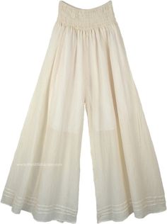 A pair of palazzo pants in ivory off white that you can wear in every season, these pants are extremely comfortable and are made of lightweight cotton fabric. The bottom of the pants is very wide, which gives it a flow and a feminine look as you walk. These pants have pin tuck details at the bottom near the hemline. Perfect for summer evenings out with friends, you can simply wear these casual wide-leg pants with a solid top of any color you like according to the occasion. Wear some jewelry to e Off White Cotton Wide Leg Pants For Spring, Chic Off White Cotton Wide Leg Pants, Spring Off White Cotton Wide Leg Pants, White Wide Leg Harem Pants For Loungewear, Bohemian White Wide Leg Pants With Elastic Waistband, White Bohemian Wide Leg Pants With Elastic Waistband, Cream Cotton Wide Leg Pants For Spring, Cream Cotton Wide Leg Ankle-length Pants, White Cotton Wide Leg Pants For Summer