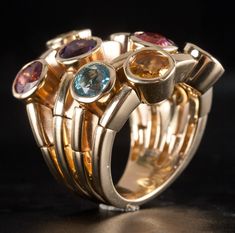 14k Yellow Gold Tourmaline Garnet Citrine Peridot Amethyst Topaz Ring 5.67ctwMetal Information: 14k Yellow GoldTotal Weight: 18.6gBand Width: 5.9mmSize: 6Designer: Sonia BStone InformationMain StoneGem Type: TourmalineShape: Round (5.0mm)Color: PinkClarity/Quality: AA - ACarat Weight: .55ctNumber of Stones: 2Accent StonesGem Type: GarnetShape: Round (5.0mm)Color: RedClarity/Quality: AA - ACarat Weight: .65ctNumber of Stones: 1Accent StonesGem Type: CitrineShape: Round (5.0mm)Color: YellowClarity/Quality: AA - ACarat Weight: .58ctNumber of Stones: 2Accent StonesGem Type: PeridotShape: Round (5.0mm)Color: GreenClarity/Quality: AA - ACarat Weight: .54ctNumber of Stones: 2Accent StonesGem Type: AmethystShape: Round (5.0mm)Color: PurpleClarity/Quality: AA - ACarat Weight: .48ctNumber of Stones: Yellow Gold Multi-stone Fusion Gemstones, Fusion Style Multi-stone Yellow Gold Gemstones, Topaz Ring, Citrine, Tourmaline, Garnet, Topaz, Amethyst, Yellow Gold